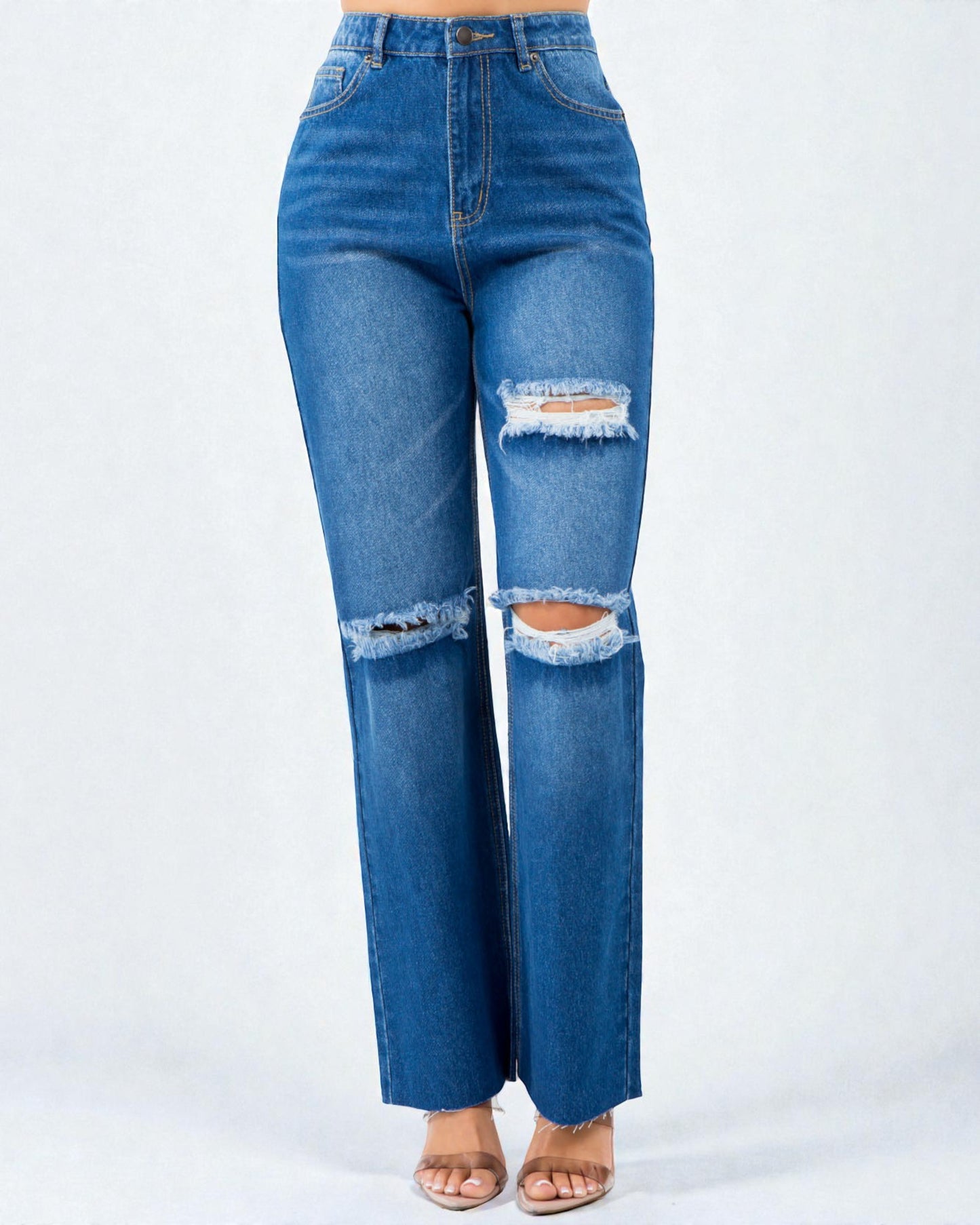 Blue jeans with distressed details on a white background