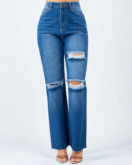 Blue jeans with distressed details on a white background