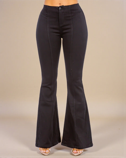 Black flared pants on a neutral background