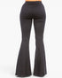 Black flared pants shown from the back on a model, featuring a high-waisted fit that transitions into a wide bell-bottom leg, photographed against a plain white background.