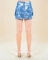 Blue denim skirt worn by a person on a beige background