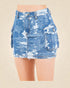Blue distressed denim skirt on a beige background