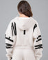 Person wearing a white hoodie with black lettering on a gray background