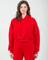 Person wearing a red hoodie and pants on a white background