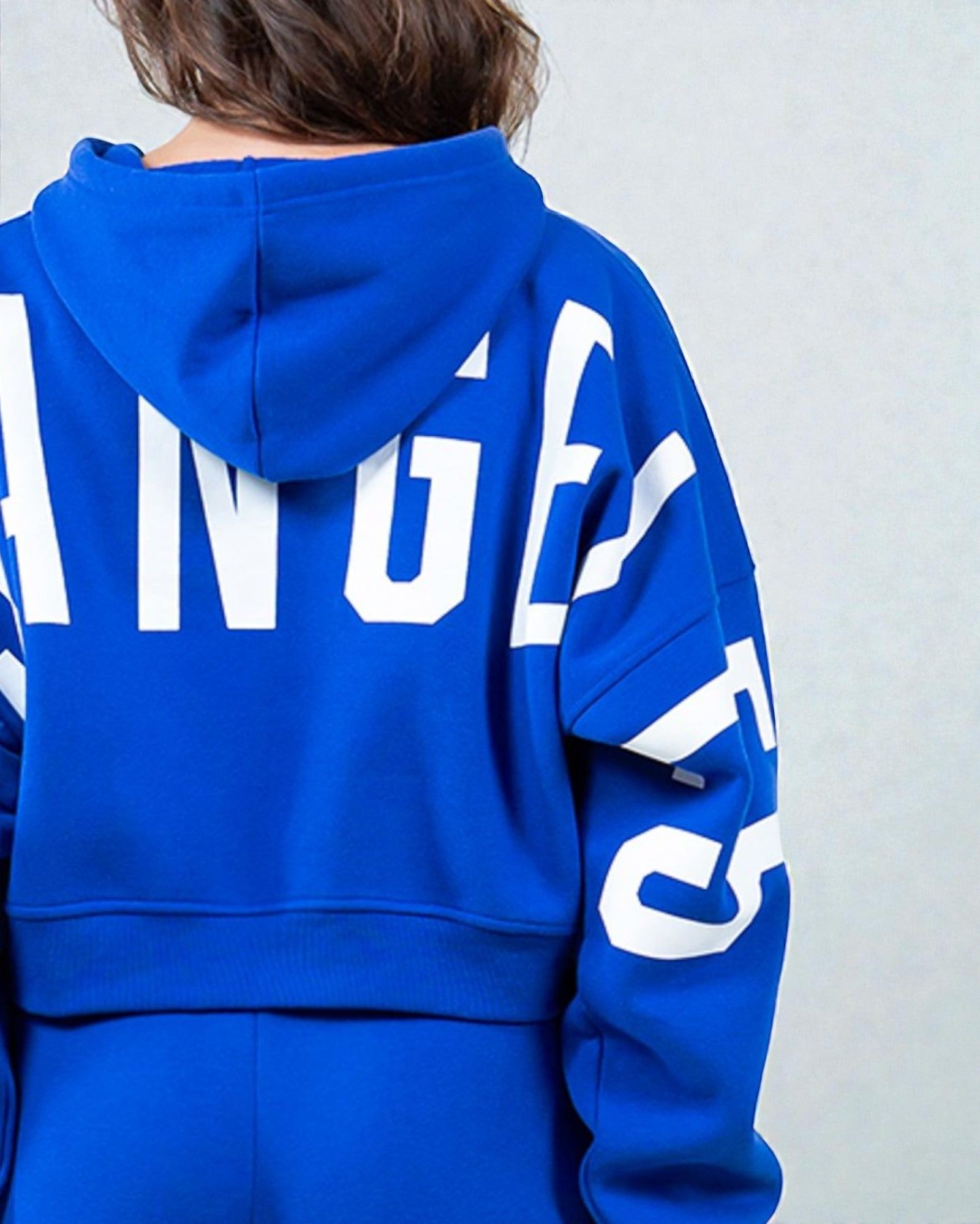 Blue hoodie with white text on a plain background