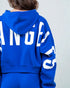 Blue hoodie with white text on a plain background