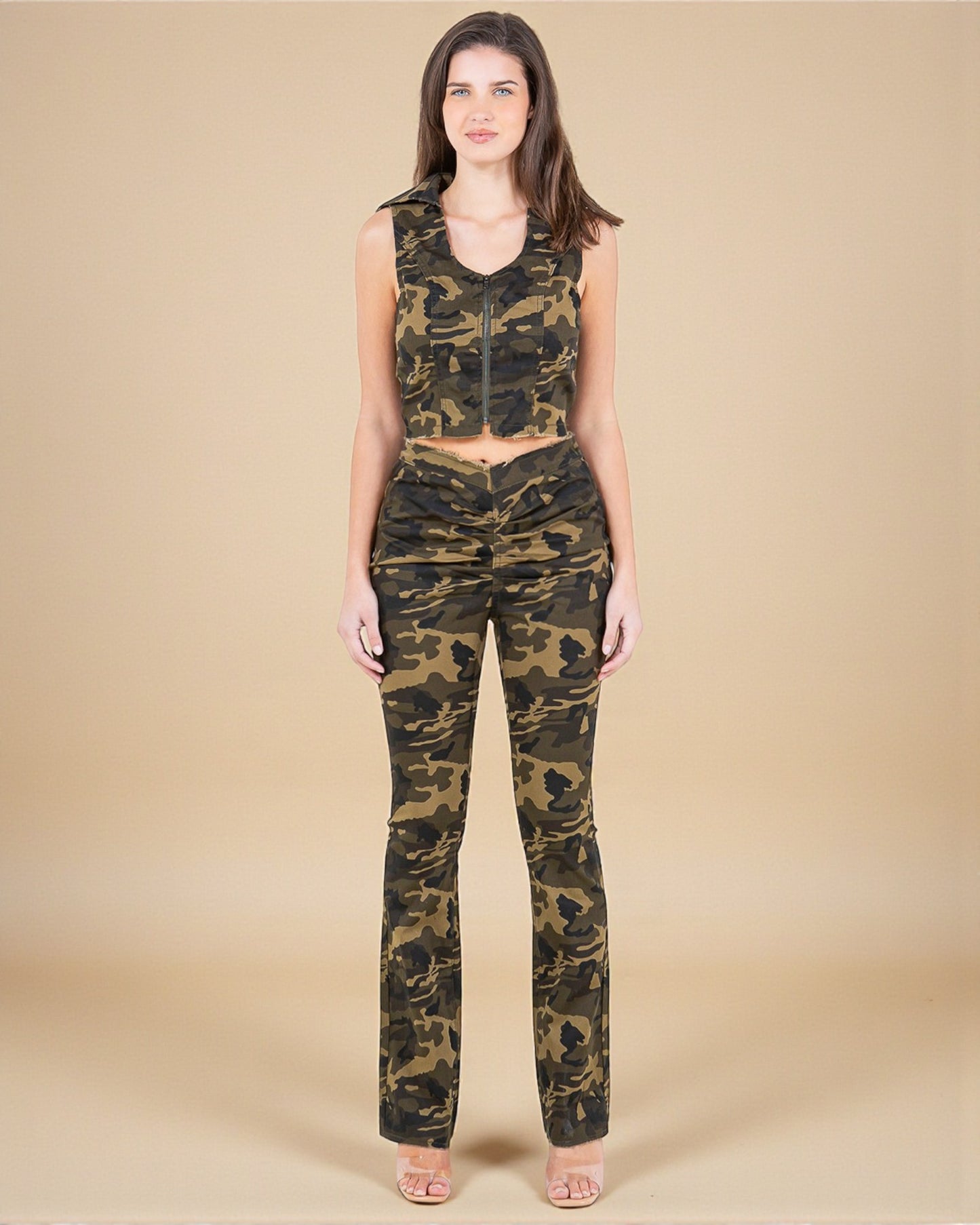 Woman wearing a camouflage outfit on a beige background