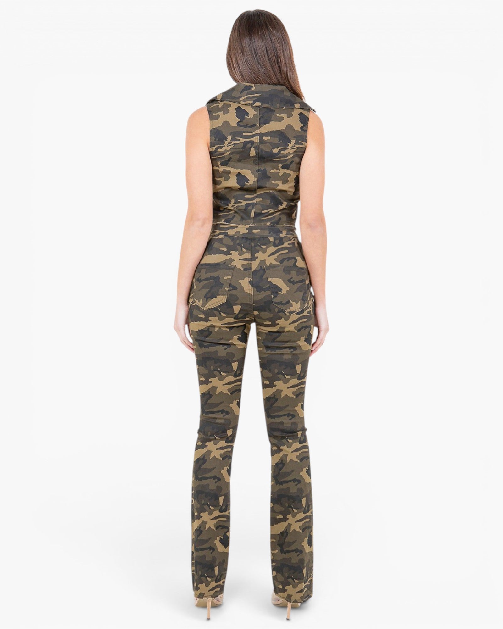 A woman viewed from the back wearing a sleeveless camouflage jumpsuit with a fitted waist and straight-leg pants, standing against a plain light gray studio background.