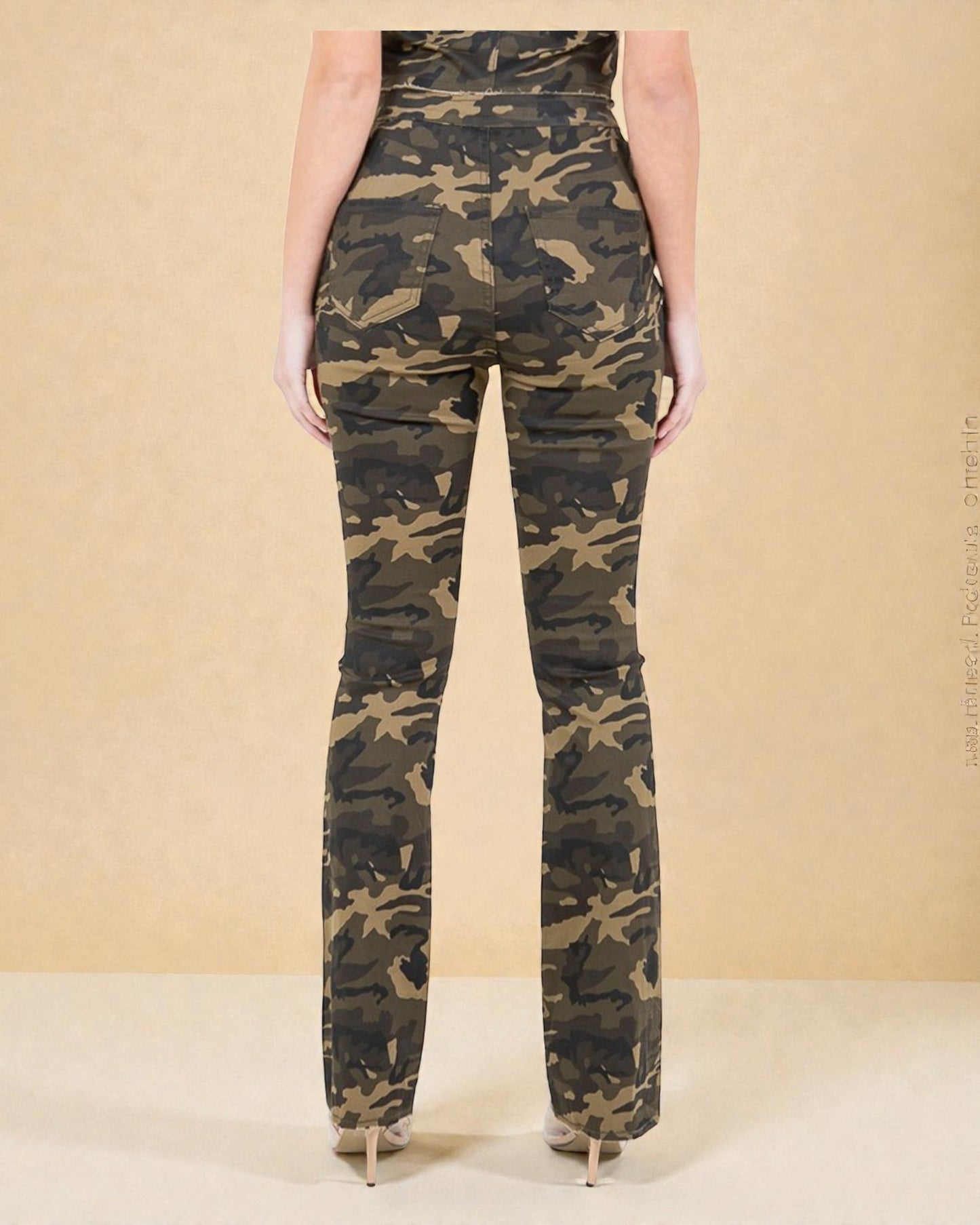 Camouflage pants worn by a person on a beige background