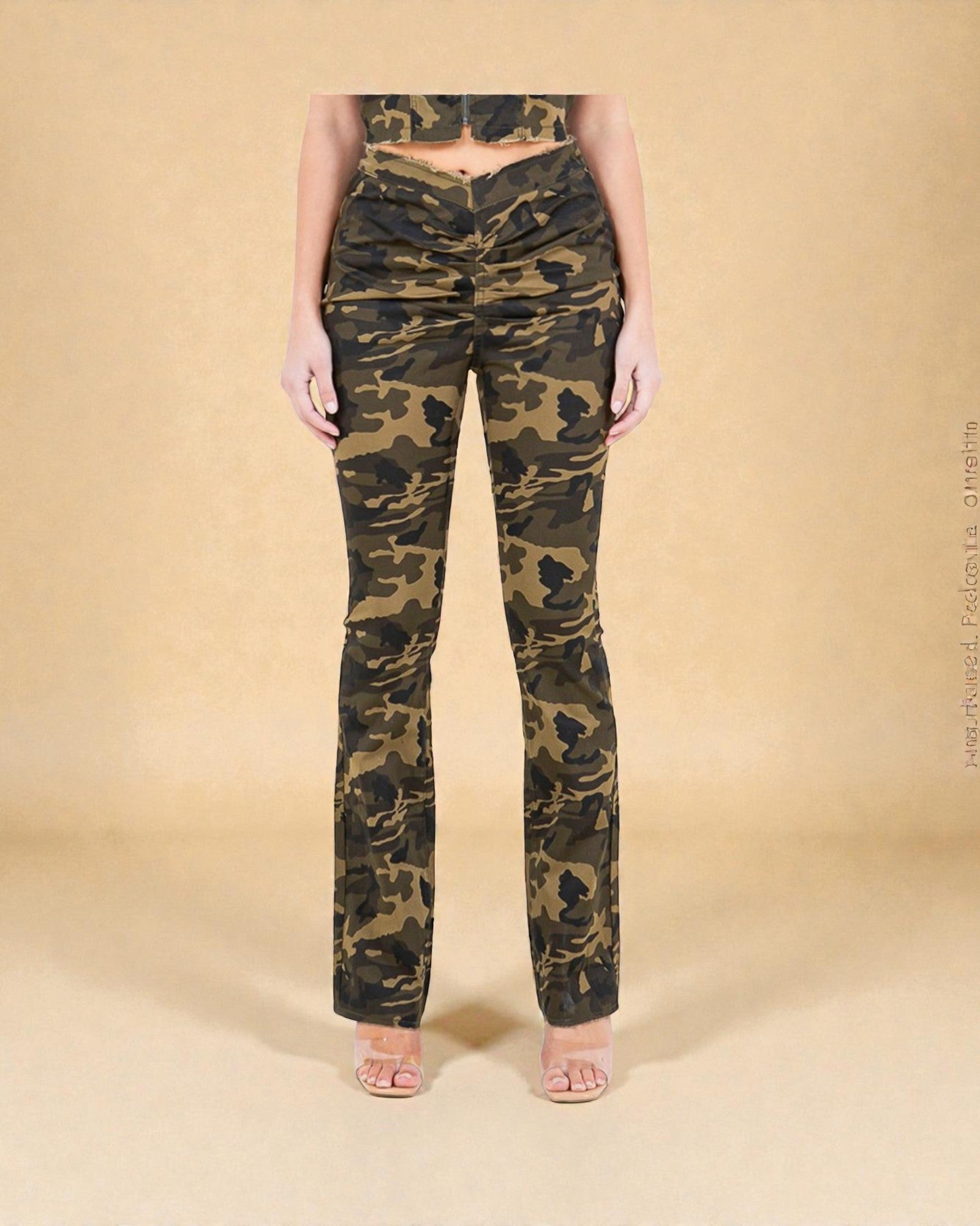 Camouflage pants worn by a person on a beige background