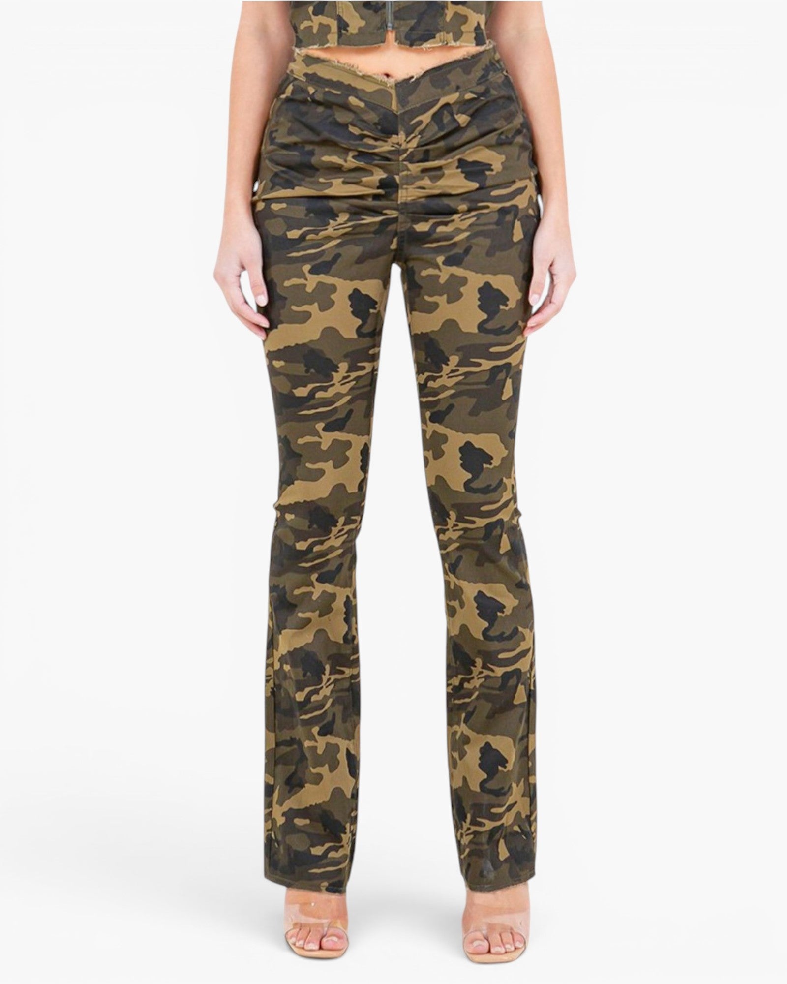 A model wearing camouflage pants with a ruched front detail, paired with a matching camouflage crop top, shown against a plain white background.