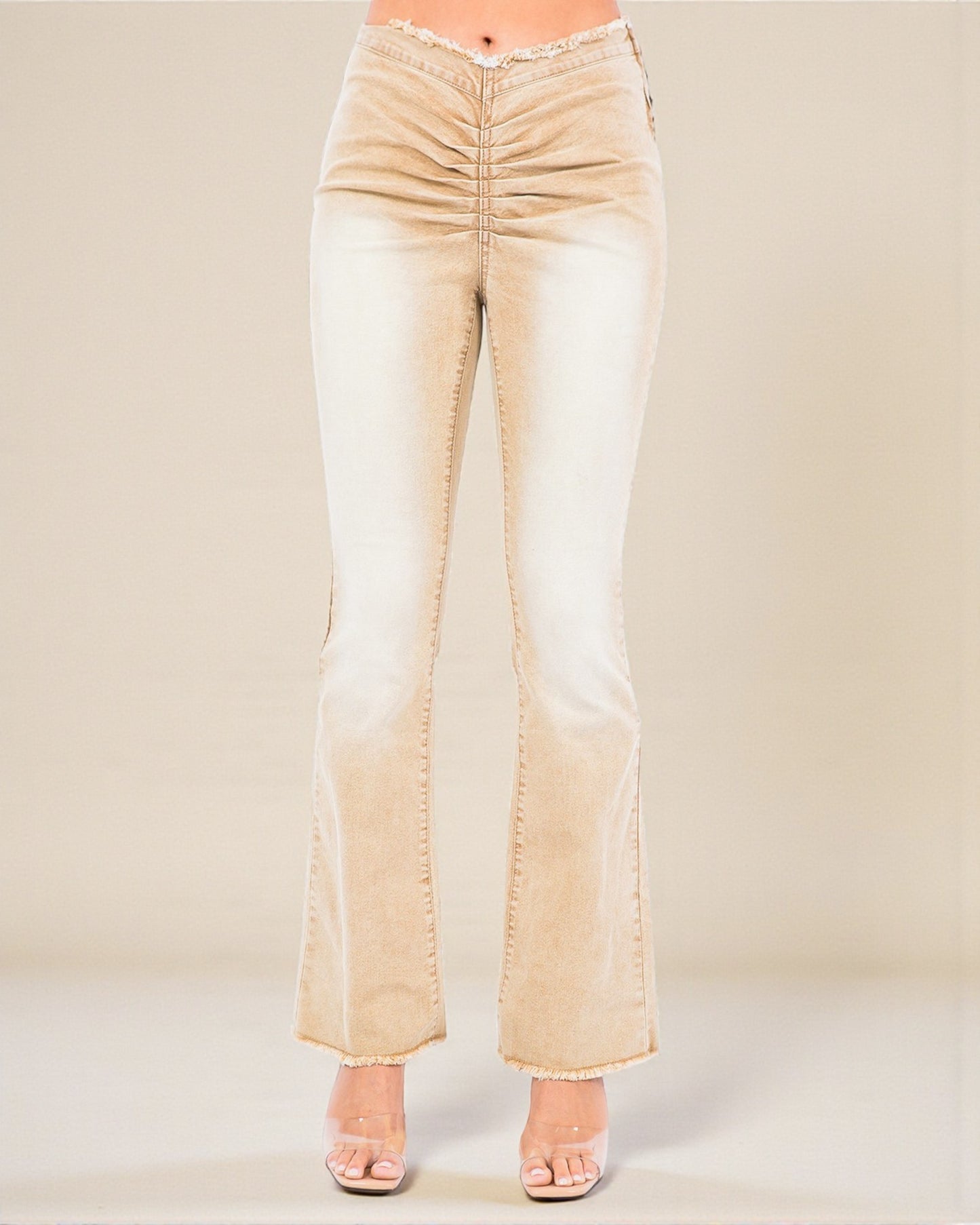 Beige flared jeans on a plain background