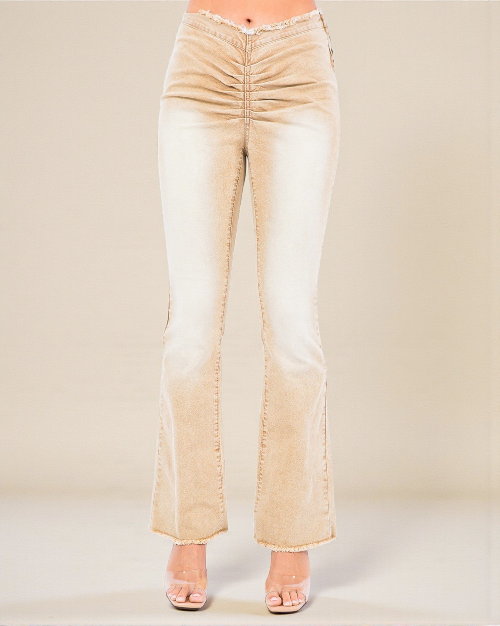Beige flared jeans on a plain background