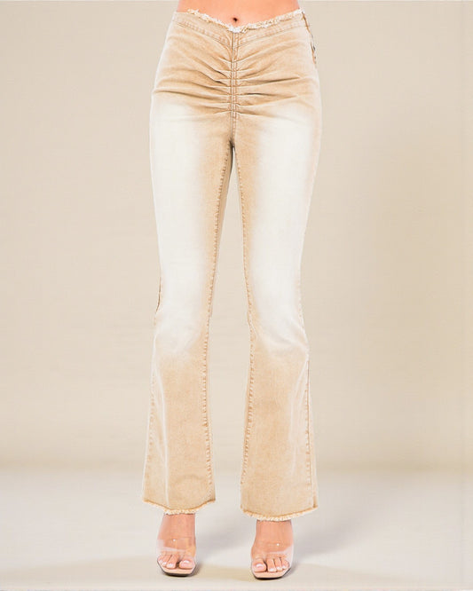 Beige flared jeans on a plain background