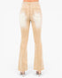 Back view of a pair of light beige flared jeans with a faded wash, shown on a model wearing nude high heels against a white background.