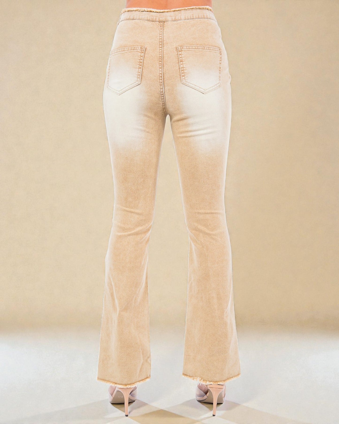 Beige flared jeans on a neutral background