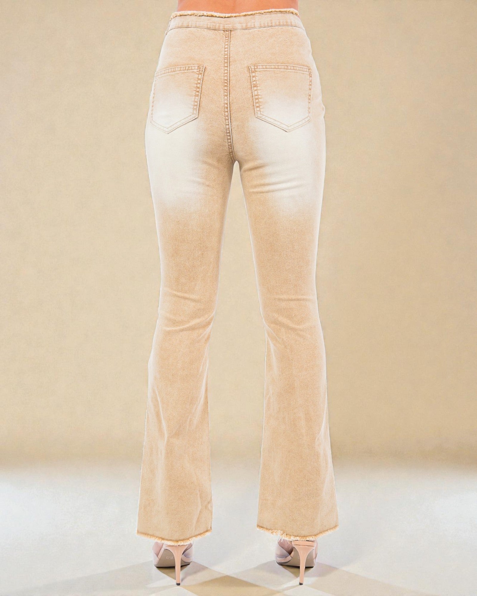 Beige flared jeans on a neutral background