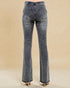 Pair of gray flared jeans on a beige background