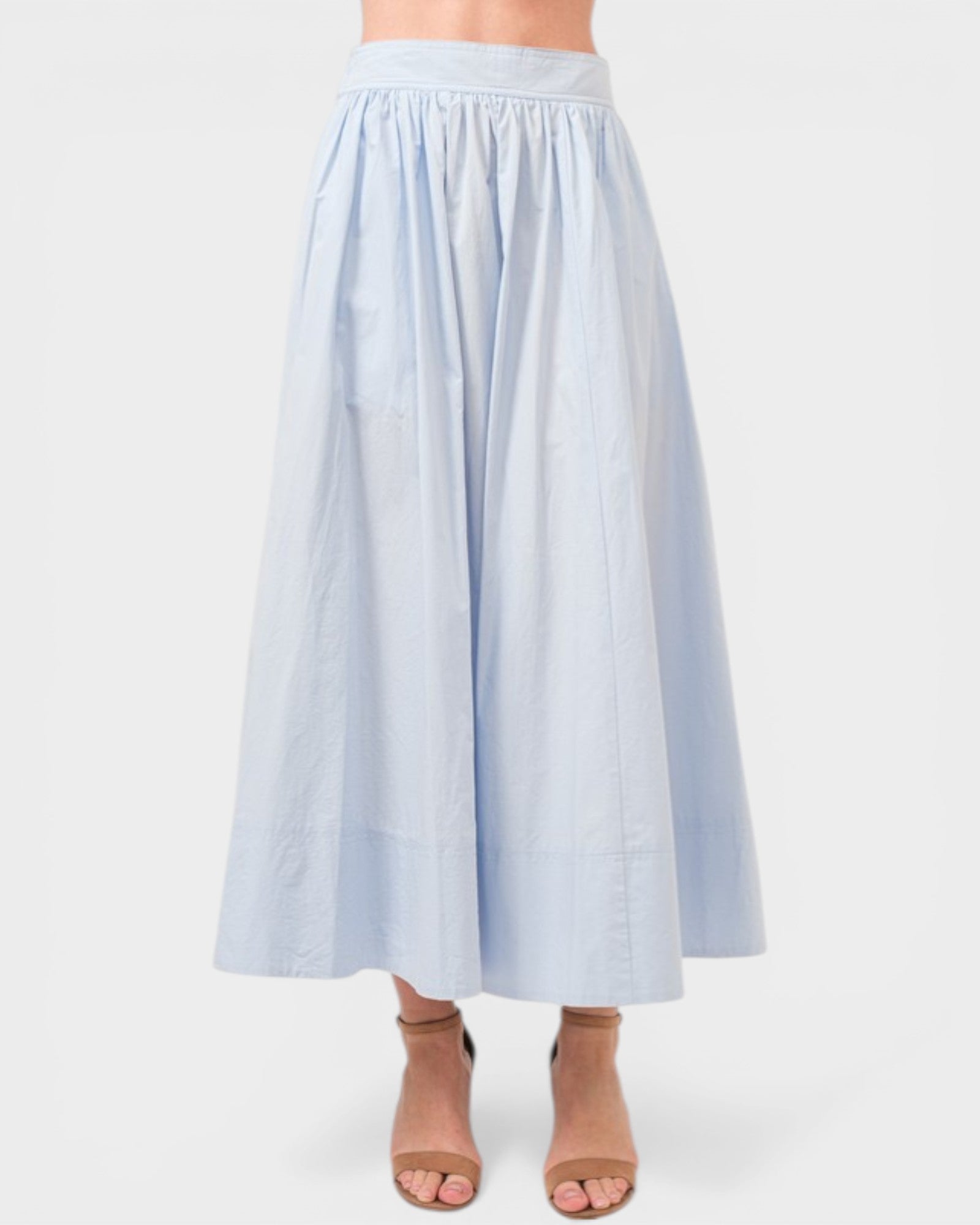 Light blue skirt worn by a person on a white background