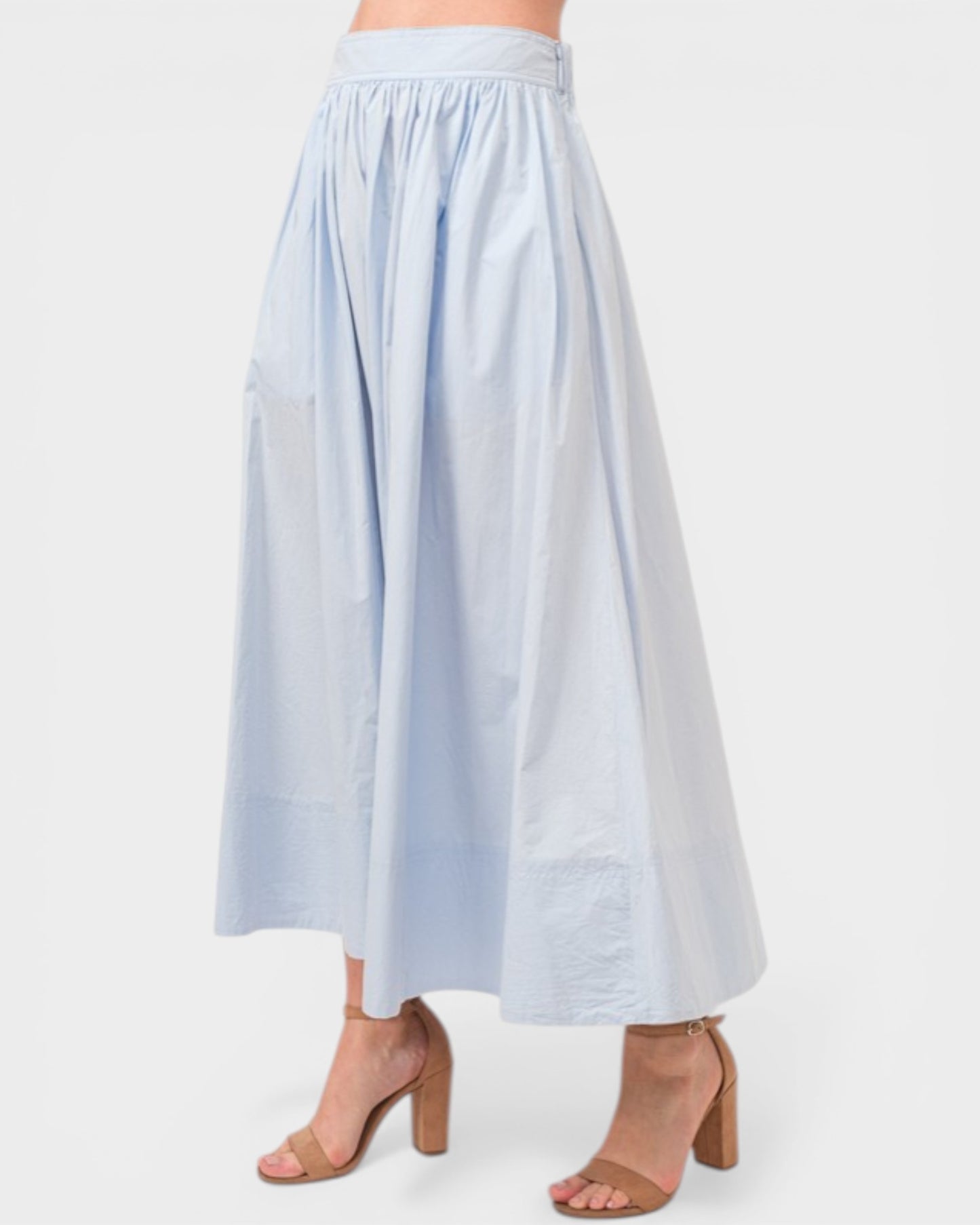 Light blue skirt worn by a person on a white background