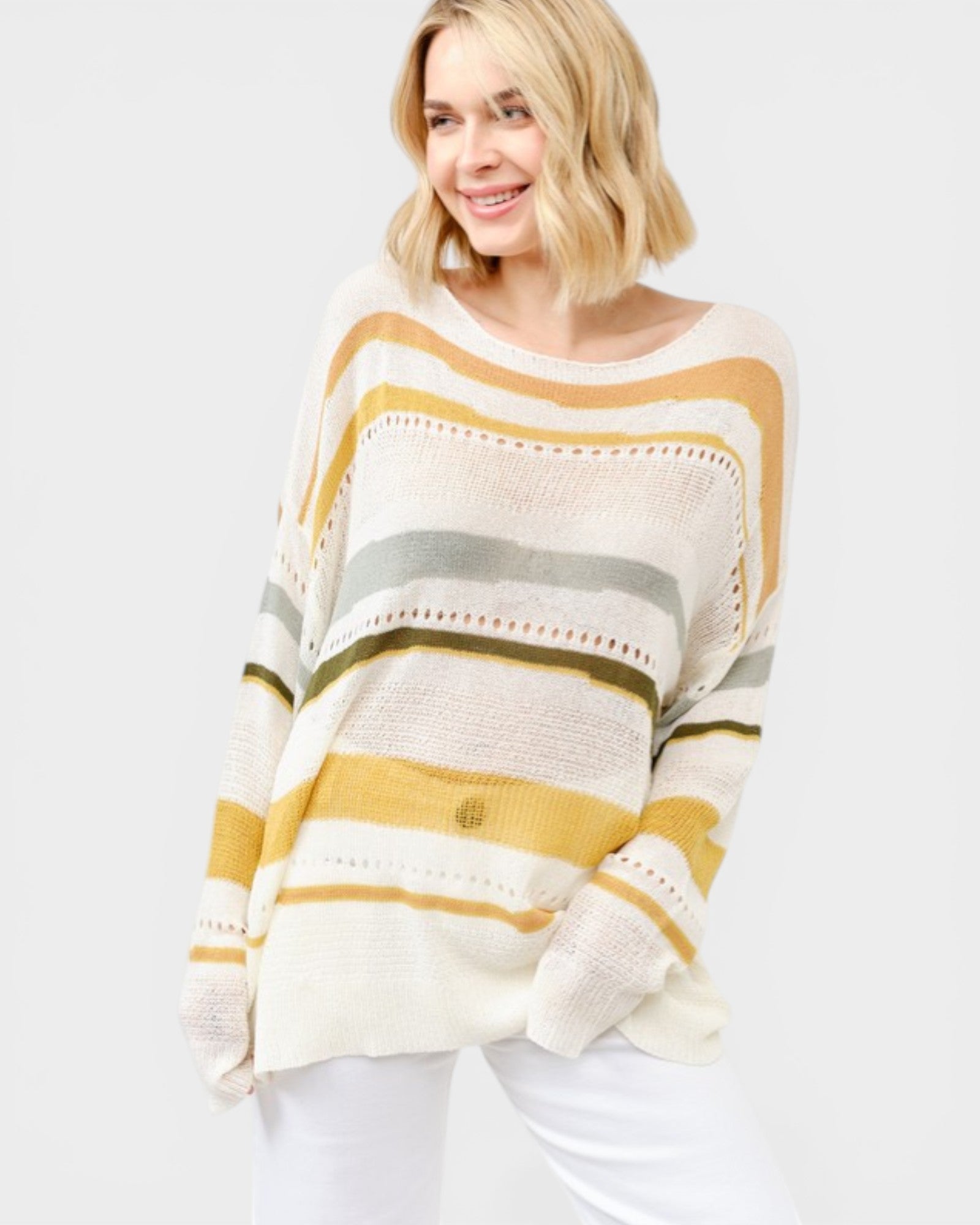 Woman wearing a striped sweater with yellow, gray, and white colors on a white background