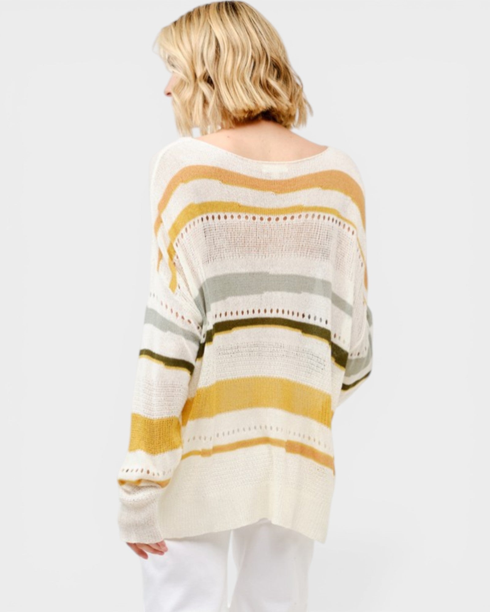 Woman wearing a striped sweater with a white background
