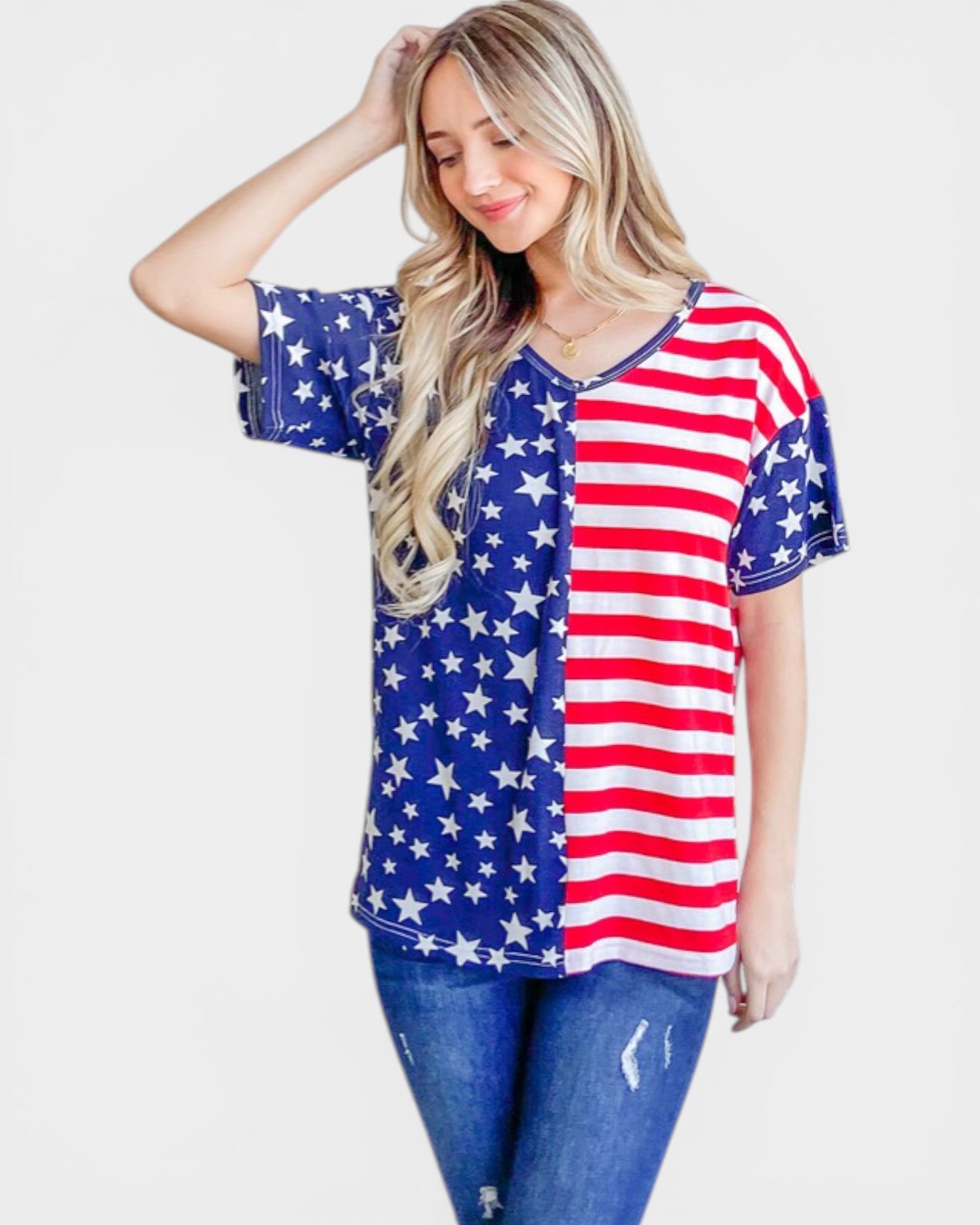 Woman wearing a shirt with an American flag design on a plain background