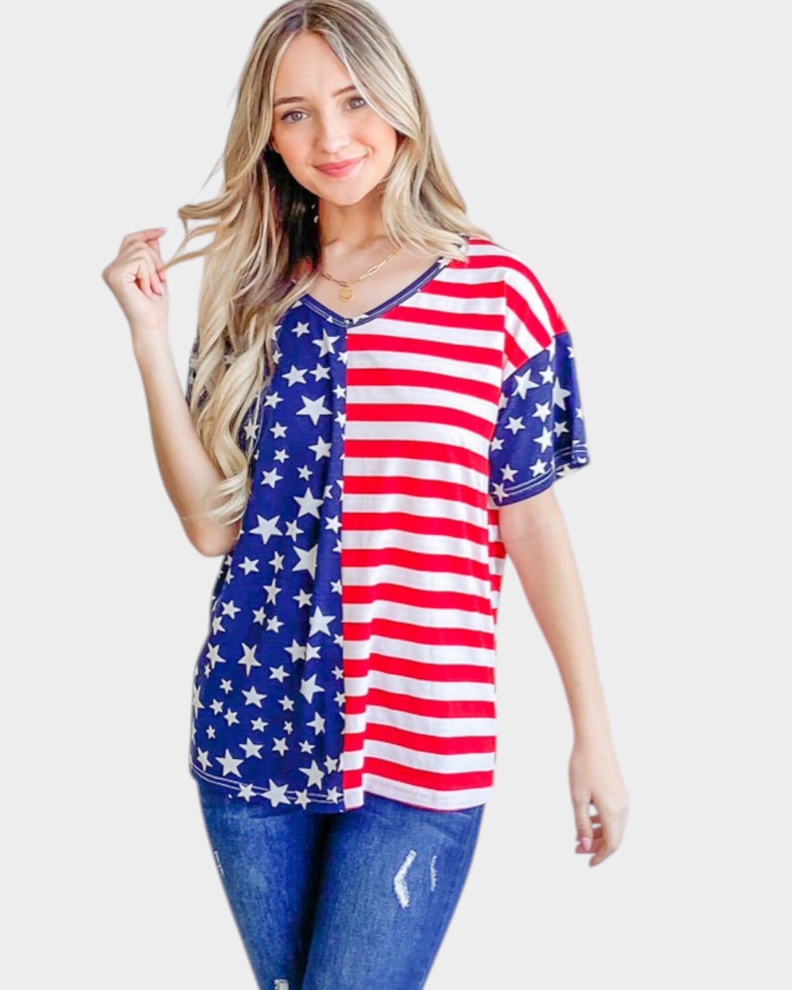 Woman wearing an American flag-themed shirt on a plain background