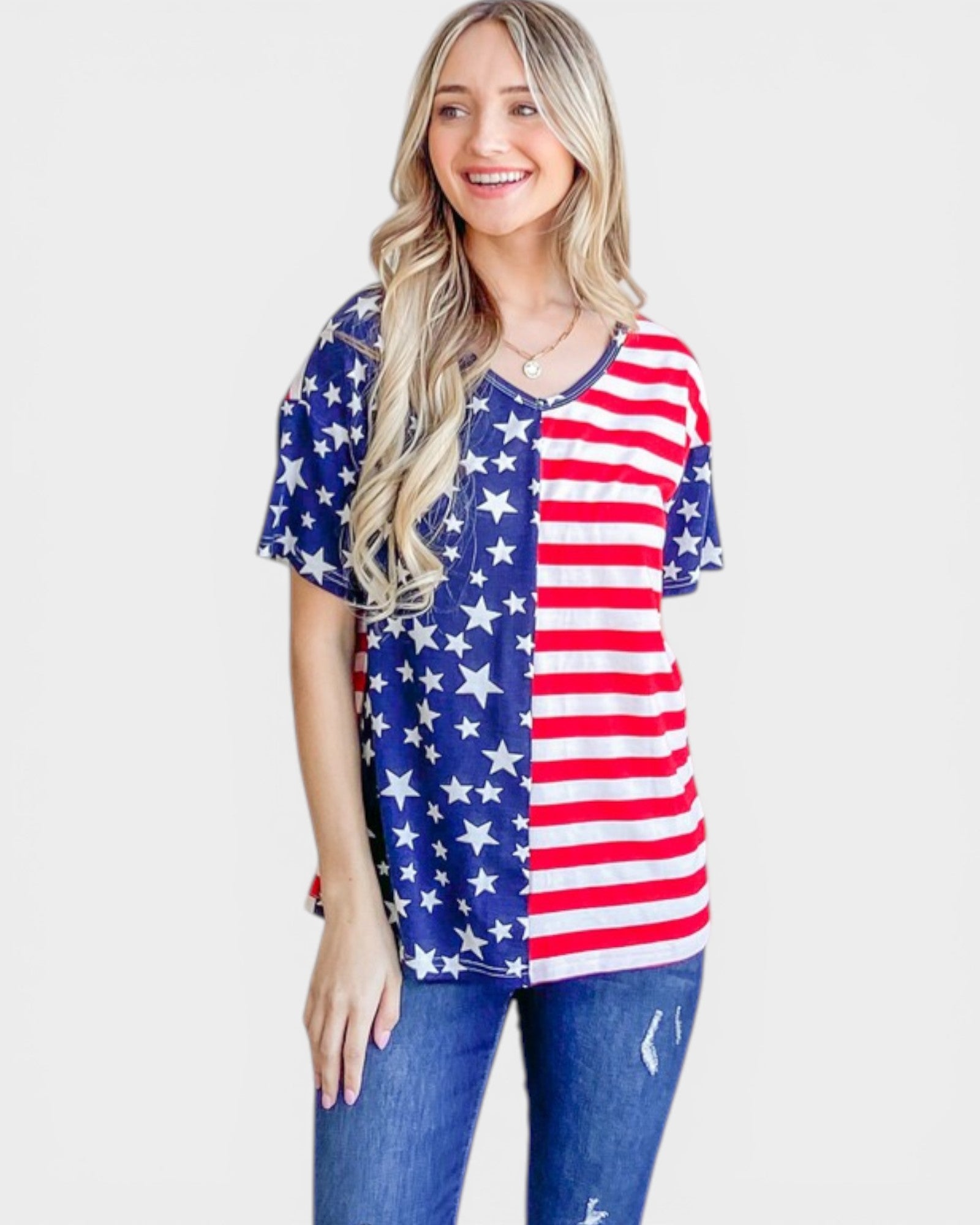 Woman wearing a red, white, and blue American flag shirt on a white background
