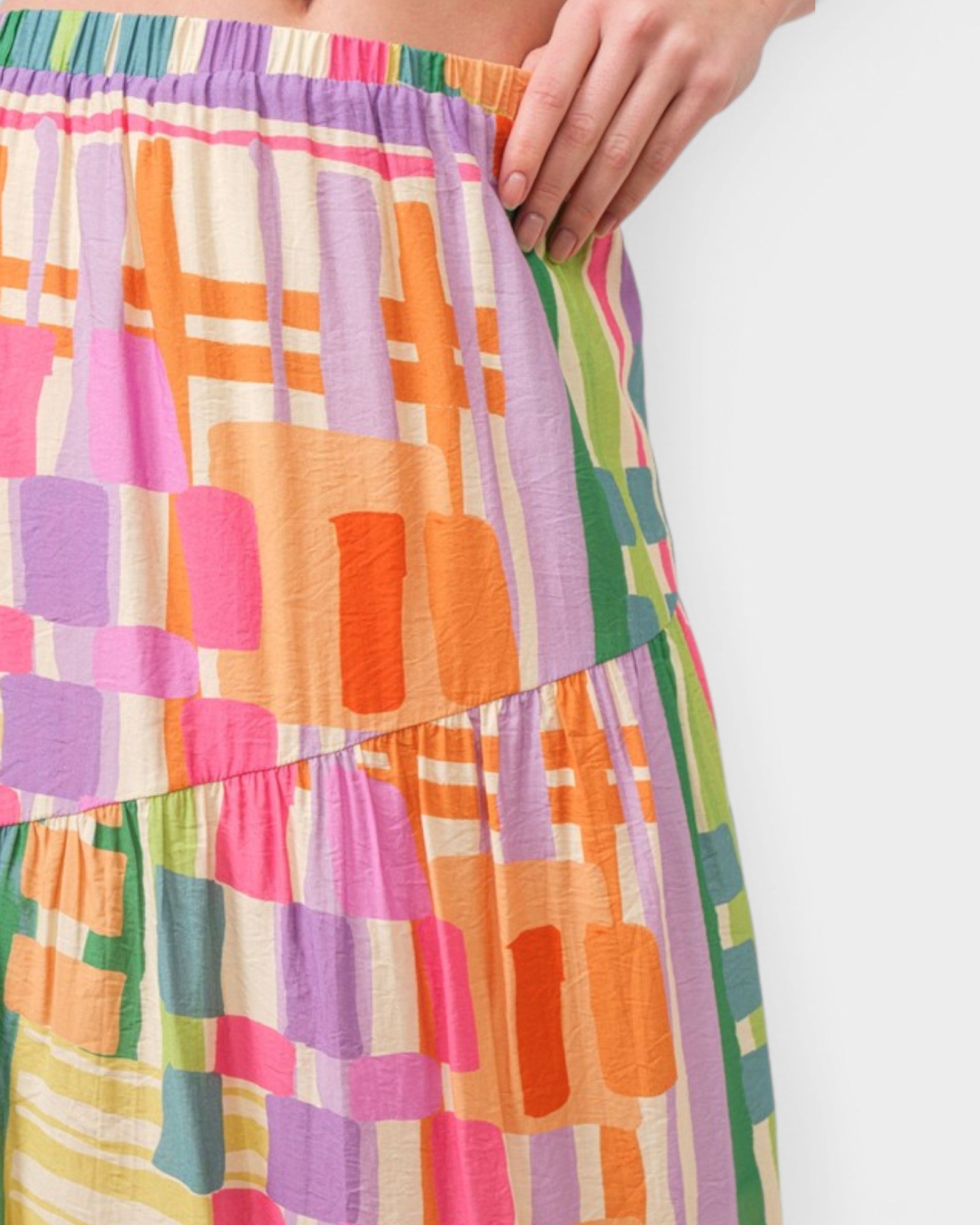 Colorful geometric patterned skirt on a white background