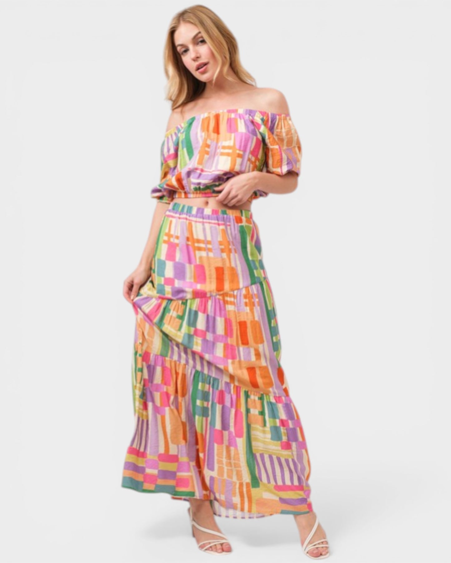 Woman wearing a colorful checkered dress on a white background