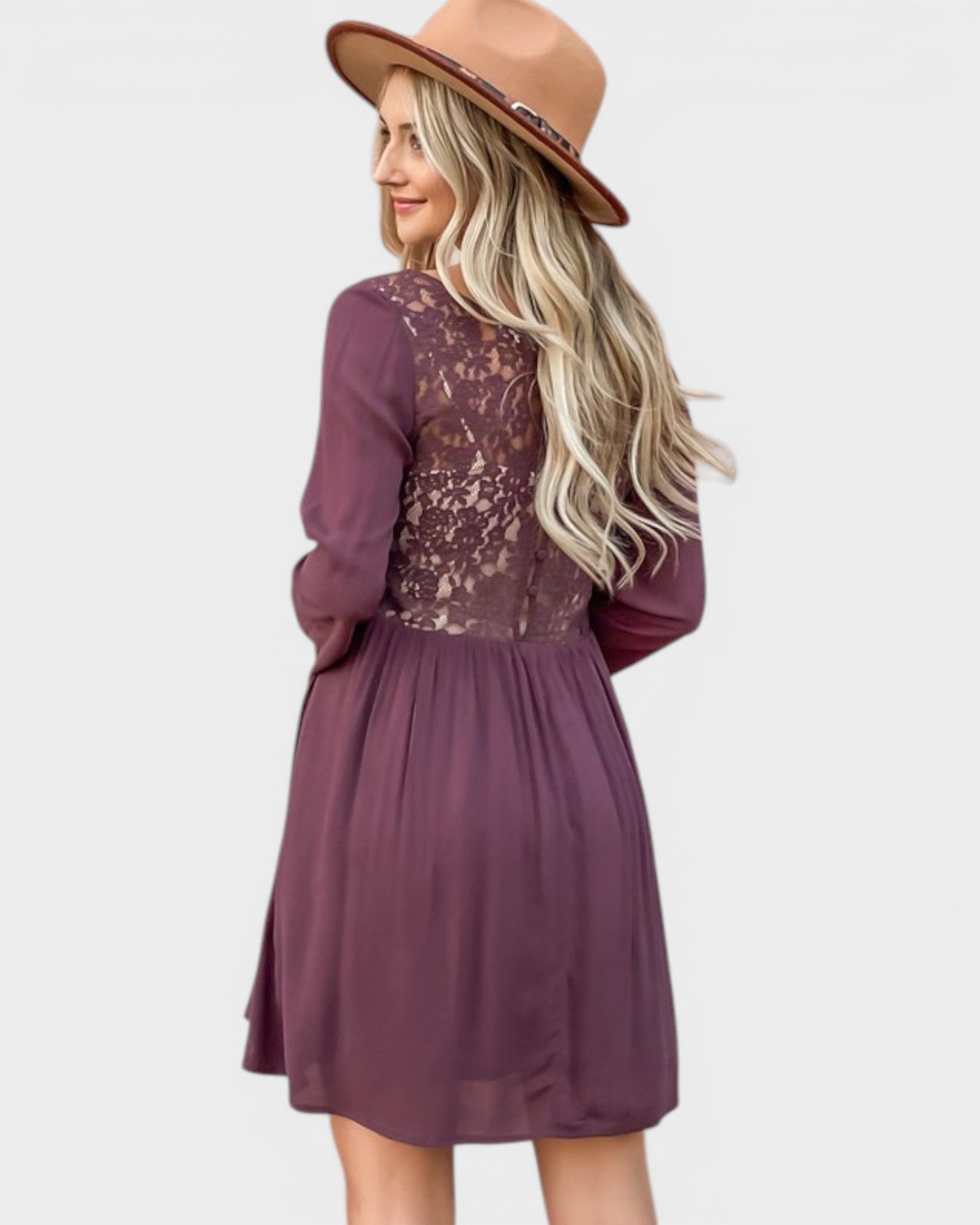 Woman wearing a purple dress with lace detailing and a brown hat on a white background