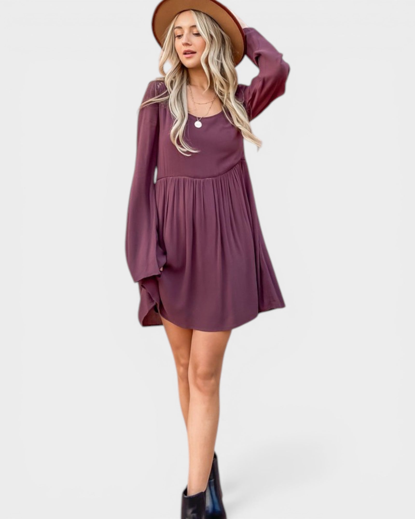 Woman wearing a purple dress with a brown hat on a white background