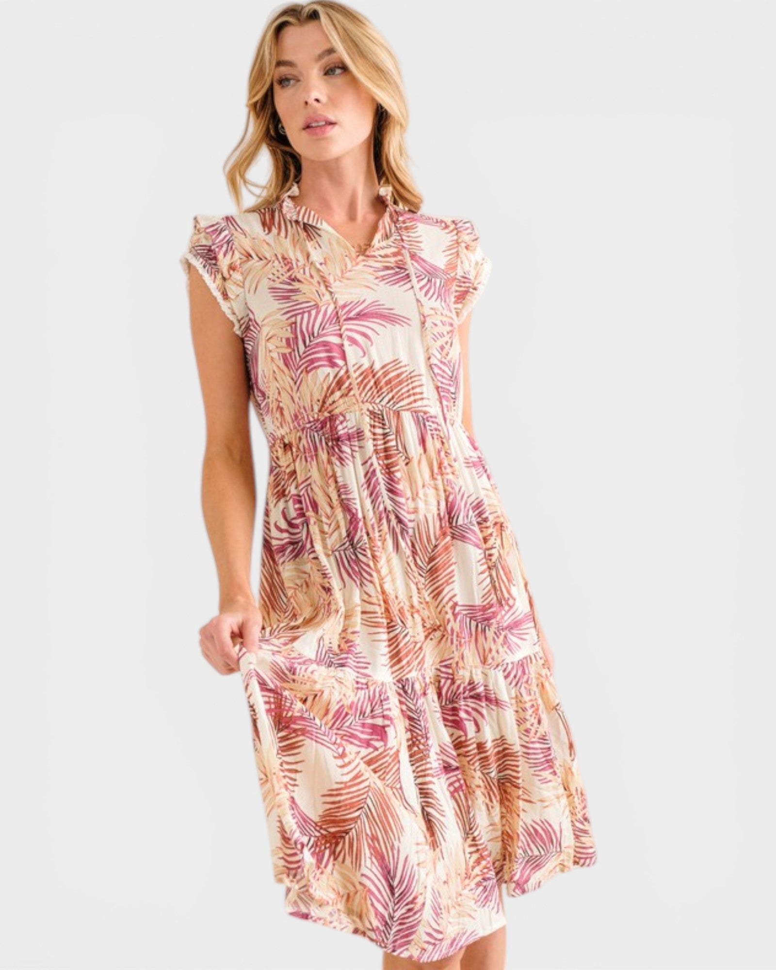 Woman wearing a patterned dress on a plain background