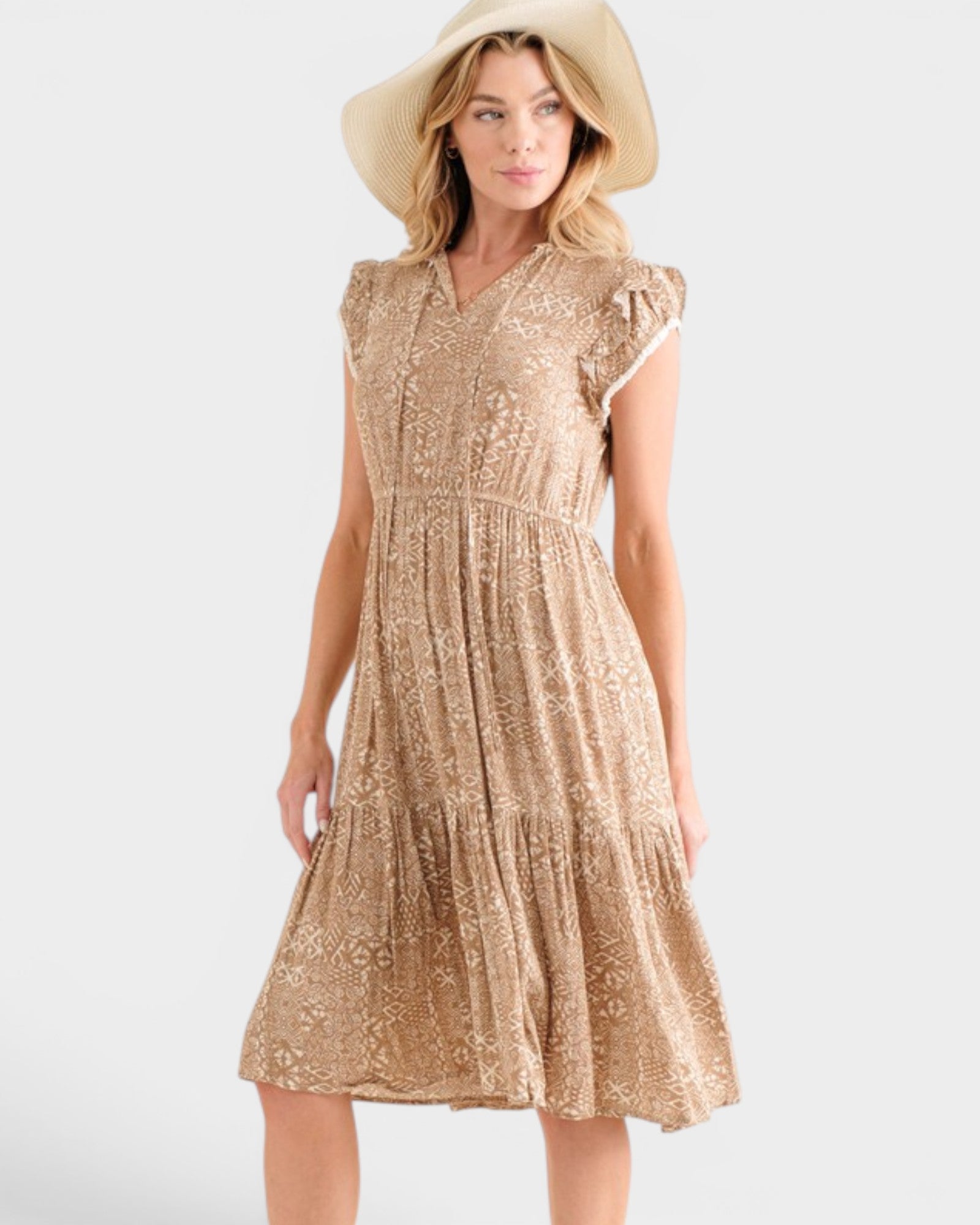 Woman wearing a beige lace dress and hat on a white background