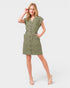 Woman wearing a green dress with buttons on a white background
