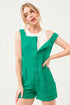 Woman wearing a green sleeveless romper on a white background