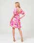 Woman wearing a colorful dress on a white background