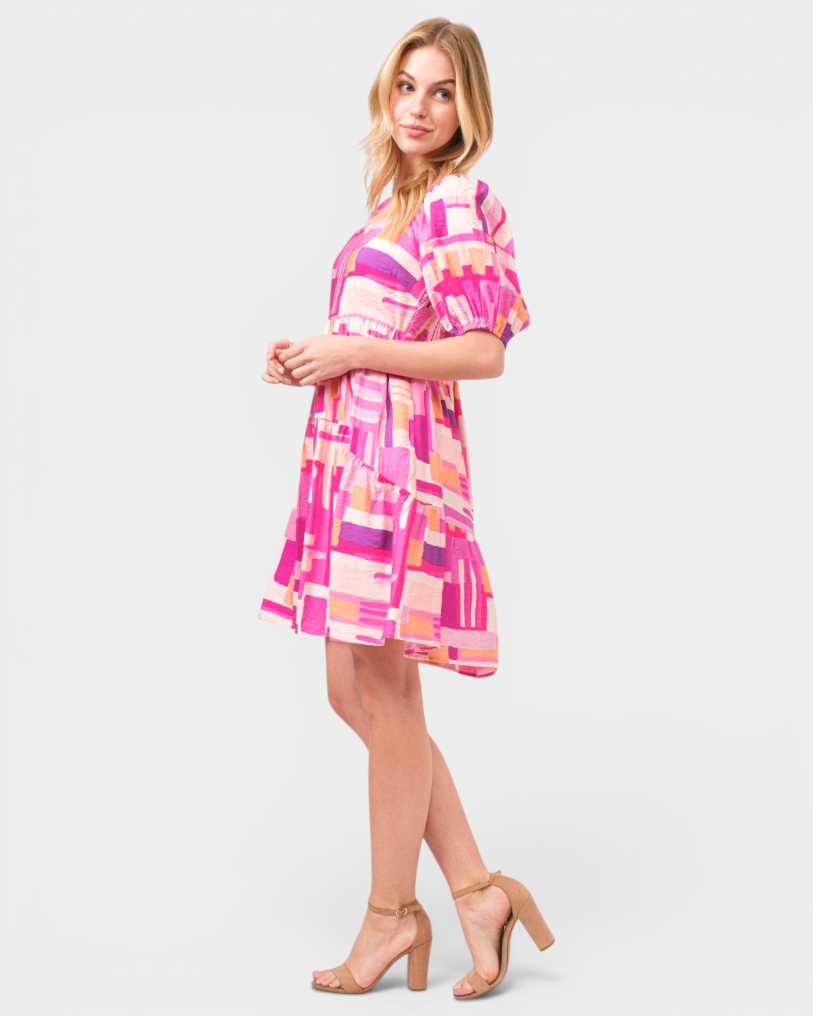 Woman wearing a colorful dress on a white background