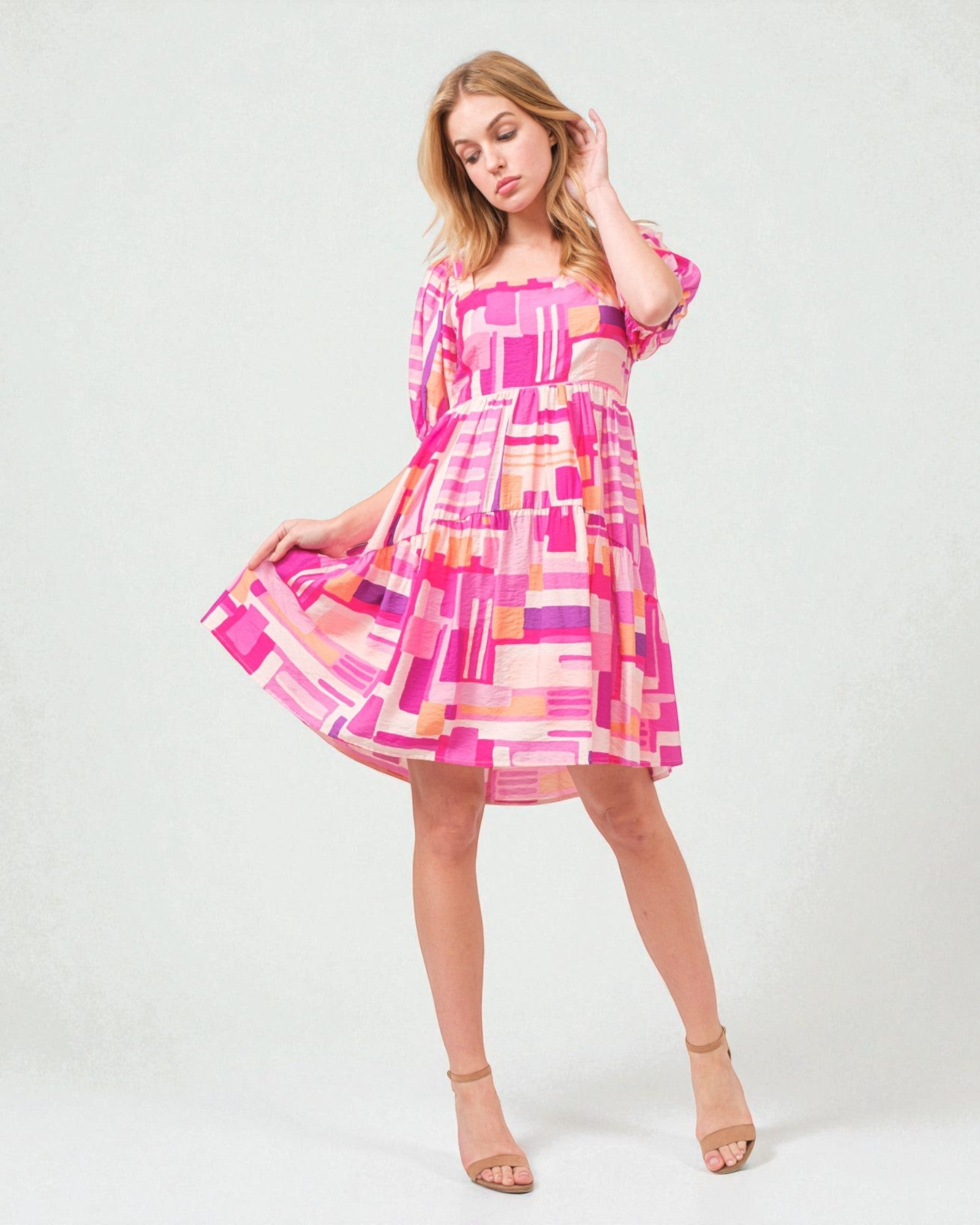 Woman wearing a colorful dress on a white background