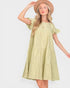 Woman wearing a light green dress with ruffled sleeves and a hat on a white background