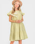 Woman wearing a light green dress and beige hat holding dried flowers on a white background