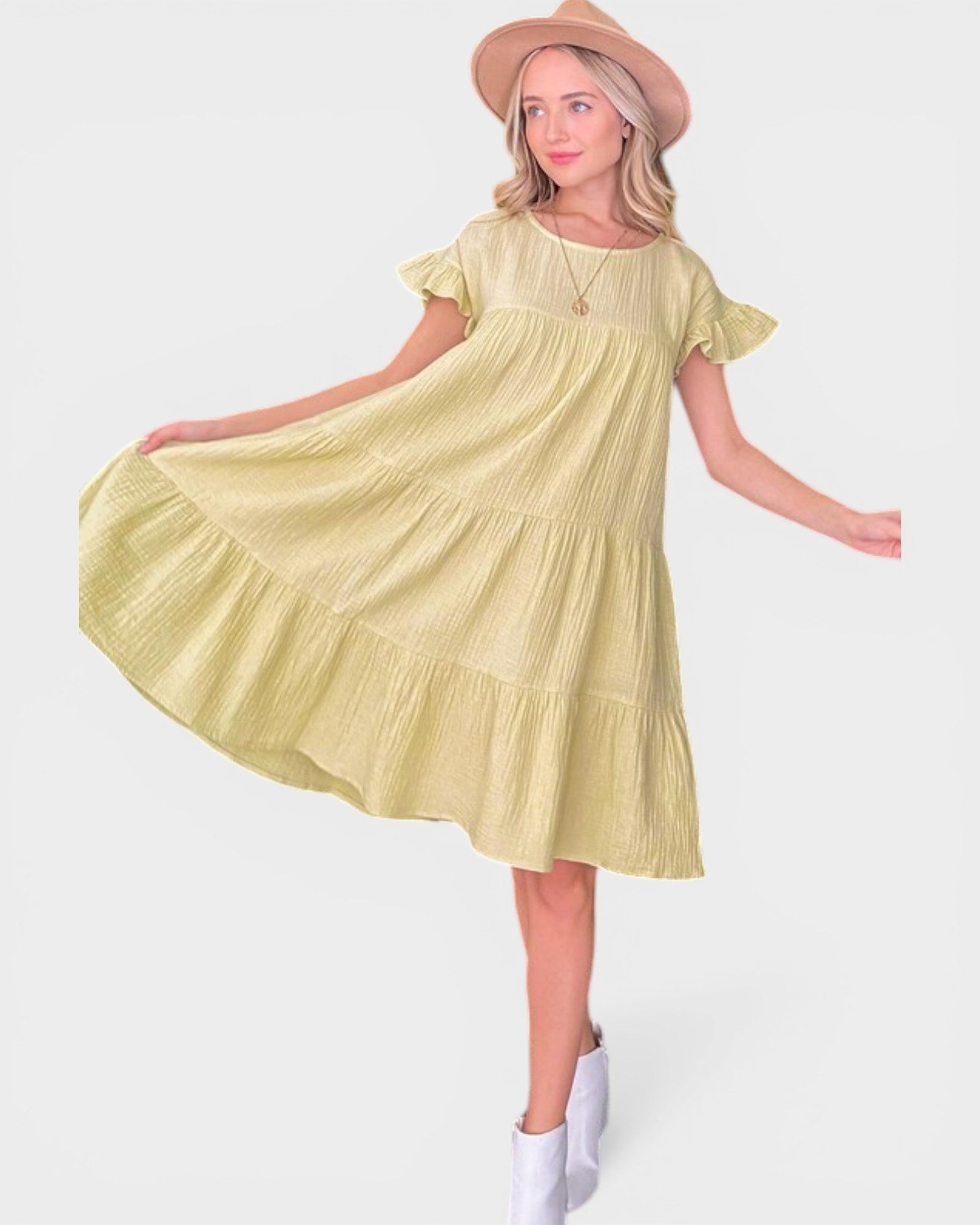 Woman wearing a yellow dress with a white background