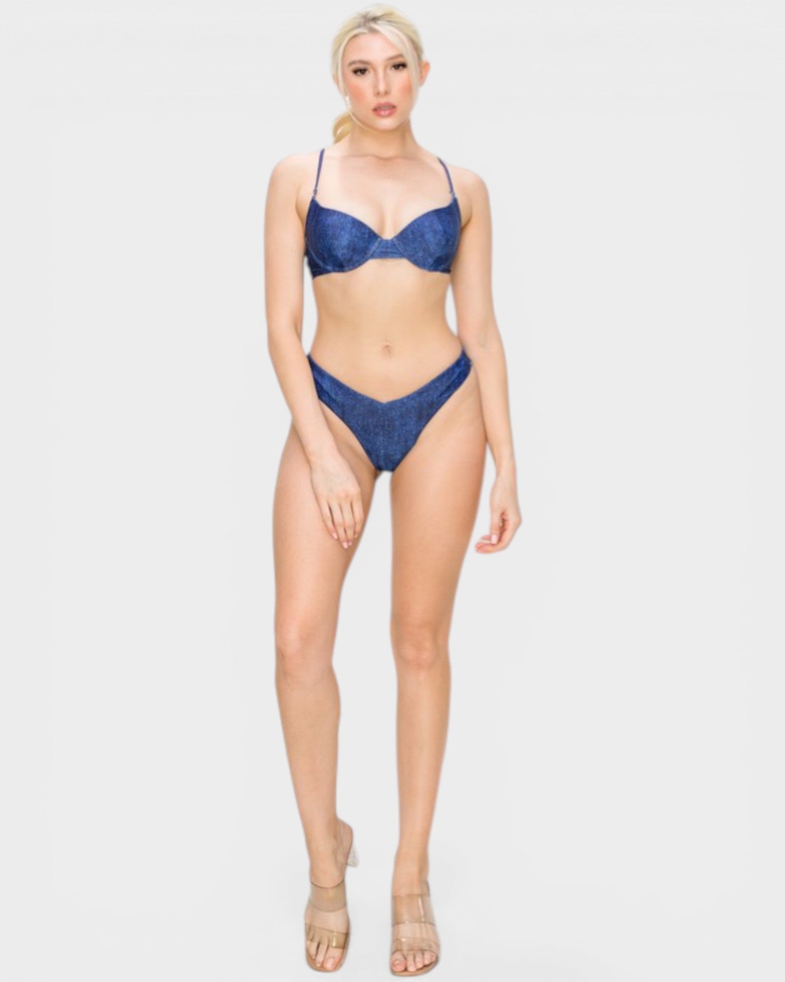 Woman wearing a blue bikini on a white background