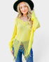 Woman wearing a bright yellow fringe sweater and black hat on a white background