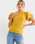 Woman wearing a yellow sweater with ruffled sleeves on a white background