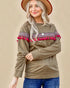 Woman wearing a brown sweater with decorative sleeves against a beige background