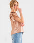 Woman wearing a beige top and blue jeans on a white background