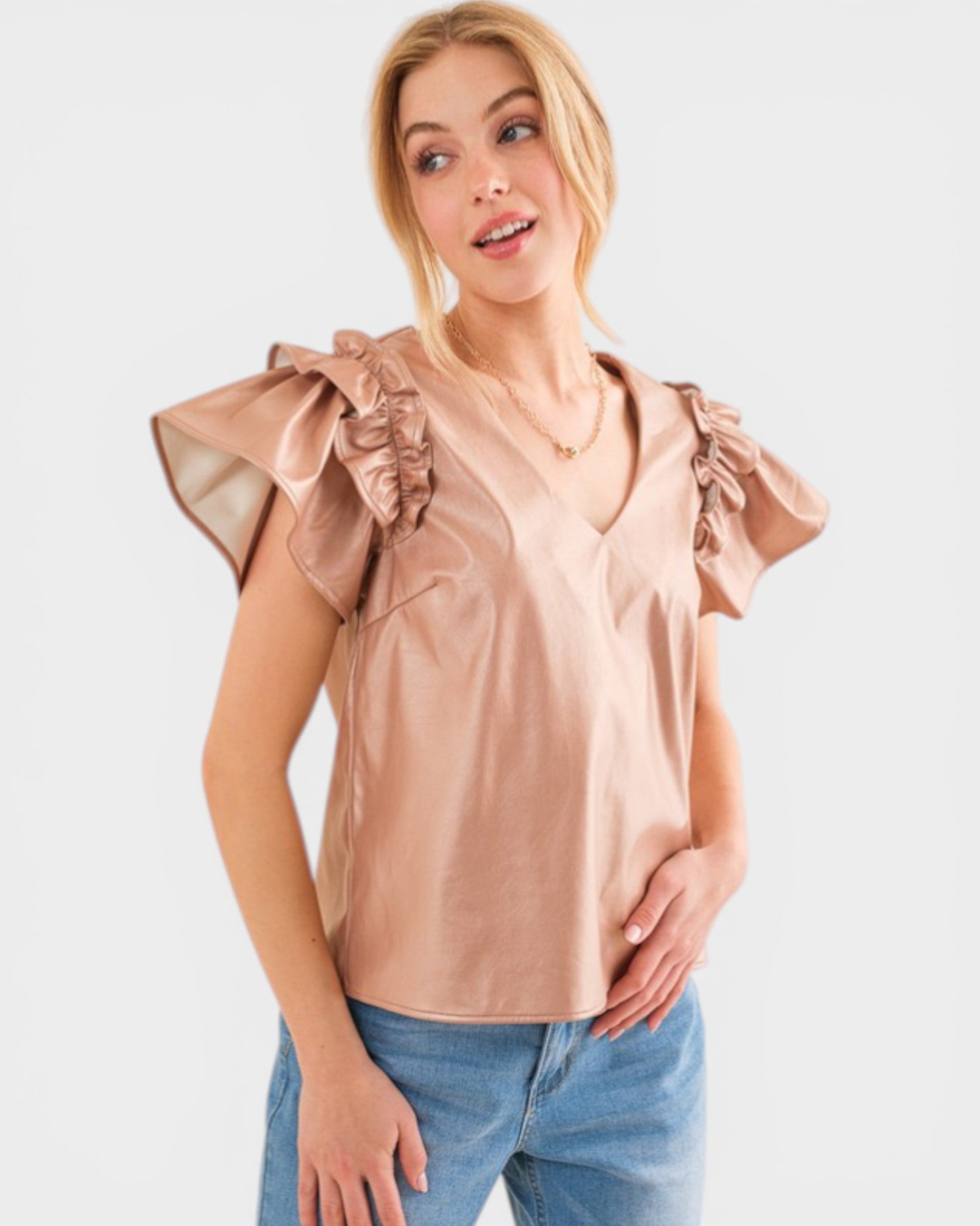 Woman wearing a beige blouse with ruffled sleeves on a white background