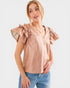 Woman wearing a beige blouse with ruffled sleeves on a white background